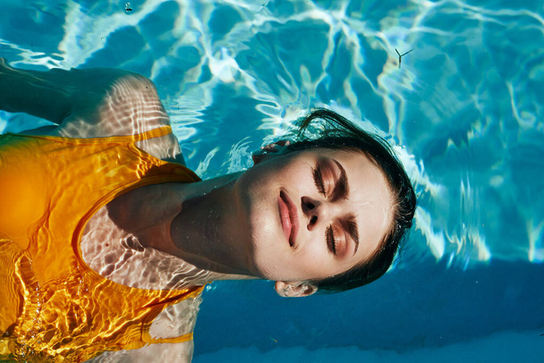 Young beautiful woman in relaxing in the pool   - Fotó, kép