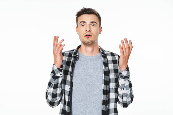 Young   man  is confused  in studio,  isolated  background - Photo, Image