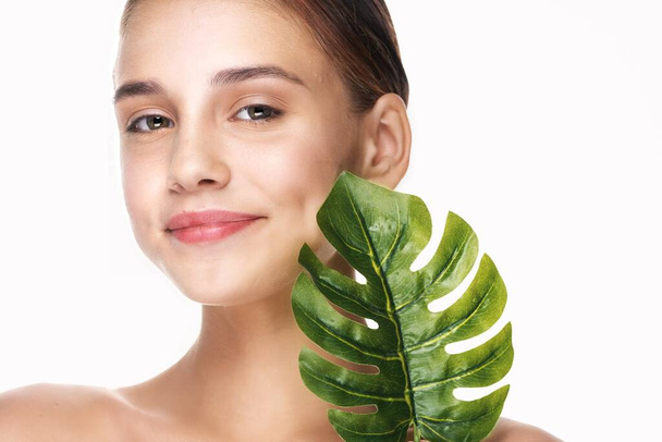 Young woman posing with the leaf in studio - Photo, Image