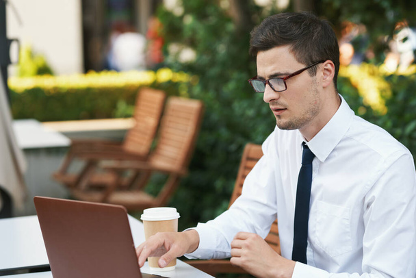 Young handsome businessman working in outdoor cafe  - Photo, Image