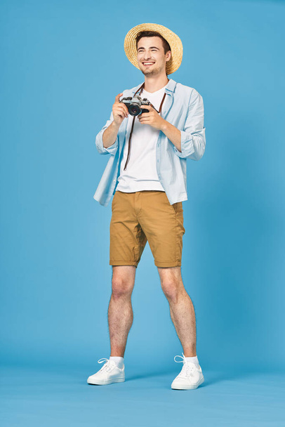 young handsome man tourist with camera in studio - Foto, imagen