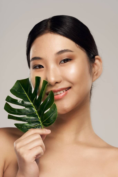 portrait of young asian woman with leaf  - Photo, Image