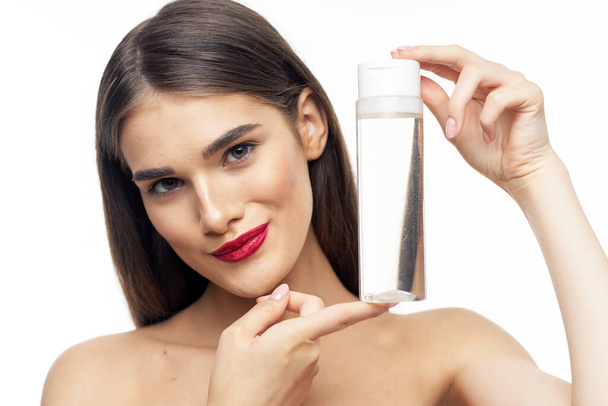  beautiful woman holding beauty product on  isolated   background - Foto, afbeelding