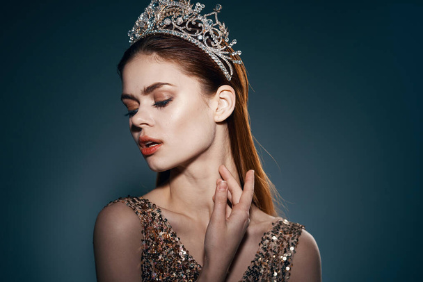 Beautiful woman with crown posing in studio. High quality photo - Photo, image