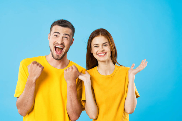 surprised young woman and man on blue background  - Фото, изображение