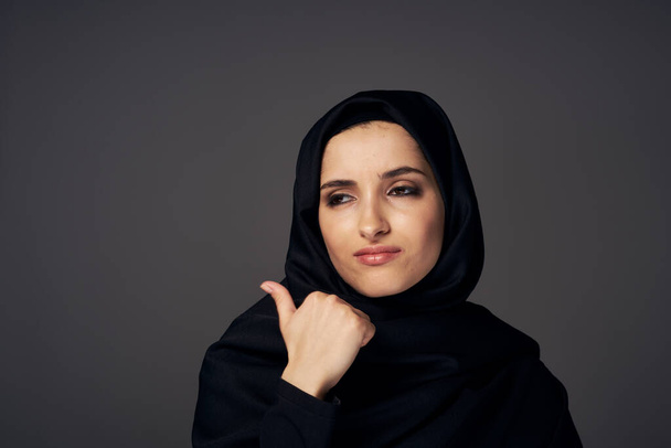 Youg muslim woman with thumb up   in studio         - Фото, изображение