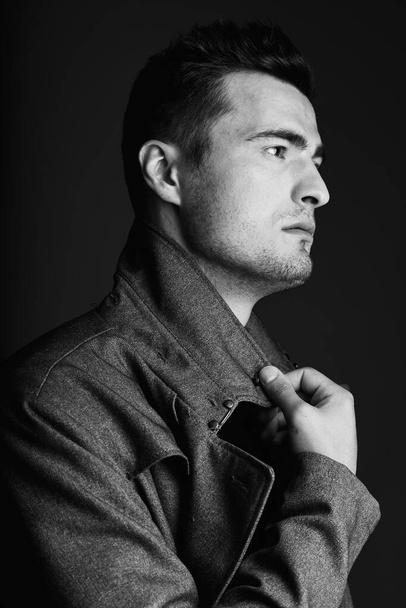 young handsome man in jacket posing in studio  - Foto, Bild