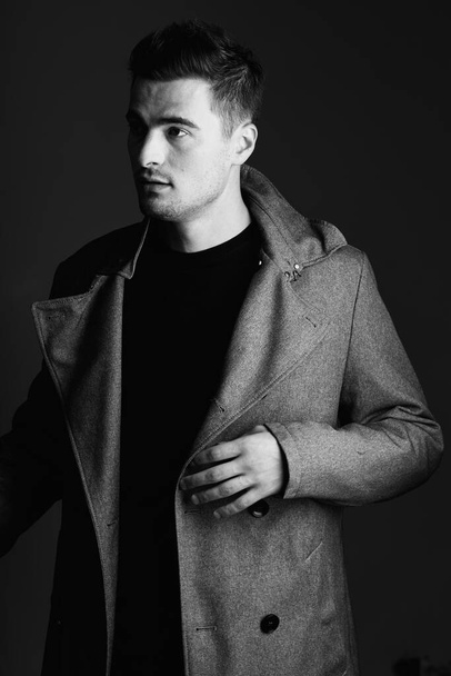 young handsome man in jacket posing in studio  - Fotoğraf, Görsel