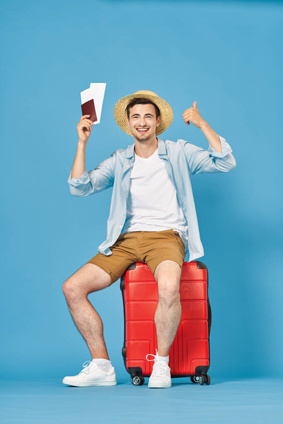 Studio shot of young man tourist with thumb up on blue  - Фото, зображення