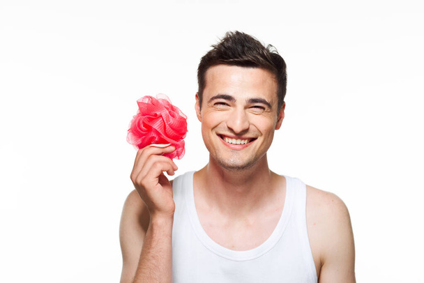 young man  with washcloth smiling   in studio on isolated background  - Photo, Image