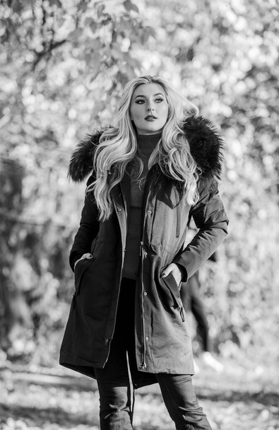 Modern outfit for youth. Girl in warm coat stand in park nature background defocused. Create fall outfit to feel comfortable and pretty. Woman long blonde hair wear stylish outfit with parka - Fotoğraf, Görsel