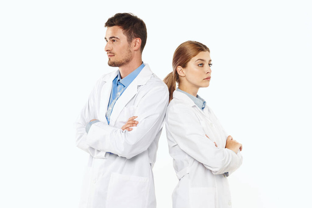 Young doctors standing in studio, isolated background.  - Photo, Image