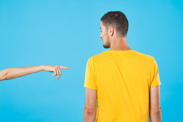 young woman pointing man on blue background  - Foto, Imagem