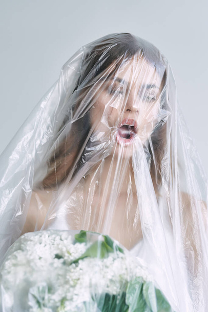 young bride covered with plastic tape  - Foto, afbeelding