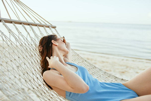 Young beautiful woman relaxing in hammock  - Photo, Image