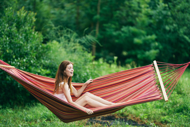 Young beautiful woman relaxing in hammock  - Photo, image