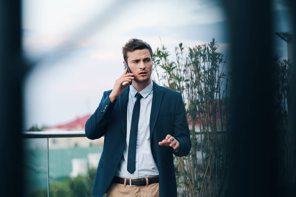 Young handsome businessman  using smartphone  - Foto, afbeelding