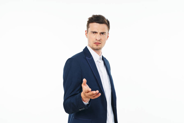 Young handsome businessman is confused on white  - Фото, зображення