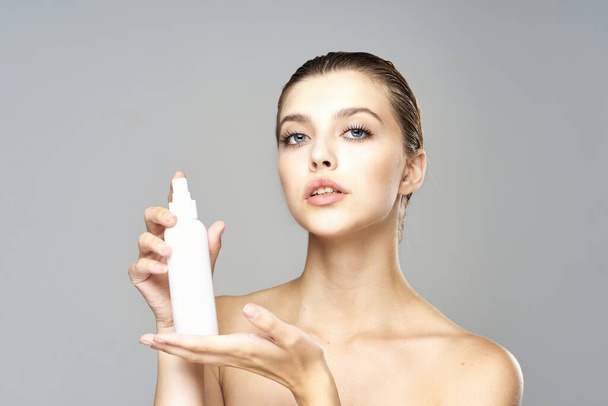  beautiful woman holding beauty product on  isolated   background - Фото, изображение