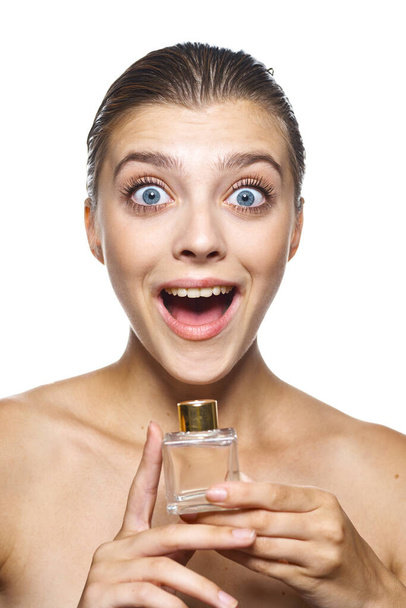 portrait  of young beautiful woman with perfume bottle,  isolated  - Photo, Image