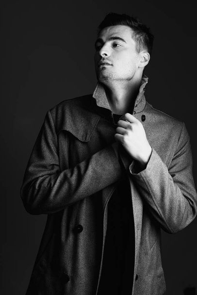 young handsome man in jacket posing in studio  - Fotó, kép