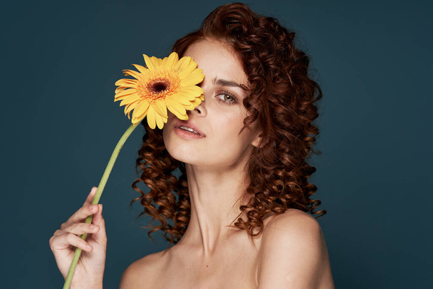 young beautiful woman with flower  posing  in studio, isolated  - Photo, Image