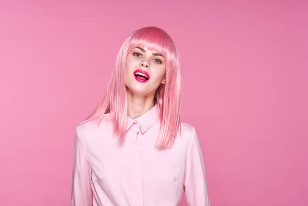 Sudio shot of beautiful woman in pink wig posing  on pink background - Photo, Image