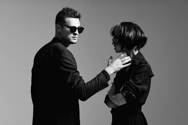 young beautiful stylish couple  in sunglasses  posing  in studio, isolated - Fotografie, Obrázek