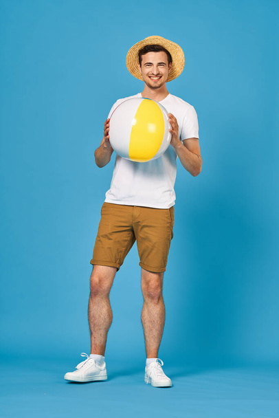 young handsome man with inflatable ball in studio  - Fotografie, Obrázek