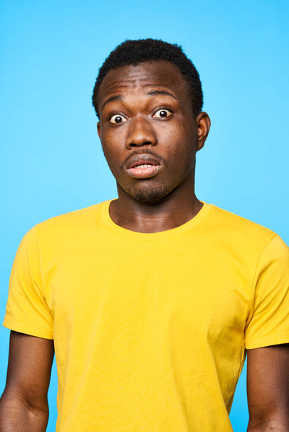 Young confused man   isolated on blue background - Fotoğraf, Görsel