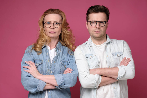 Serious business team of mature man and woman in glasses looking at camera. - Zdjęcie, obraz