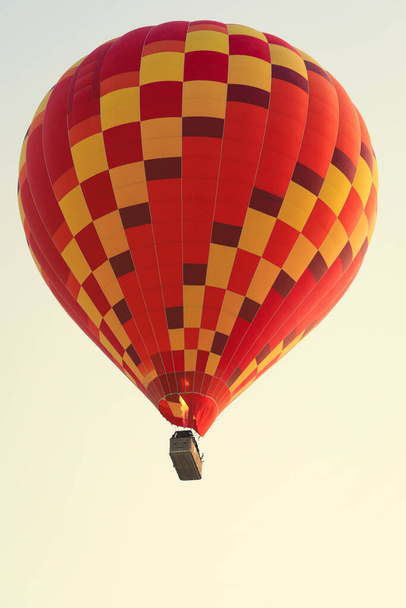 Selectieve focus op hete lucht ballon vliegen over de vallei bij Cappadocia. Warme lucht ballonnen zijn traditionele toeristische attractie in Cappadocië. - Foto, afbeelding