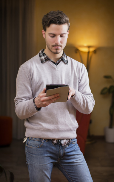 Handsome young man with tablet PC at home - Φωτογραφία, εικόνα