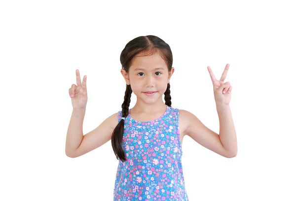 Portrait asian little child girl showing finger fight or victory sign on white background. - Fotografie, Obrázek