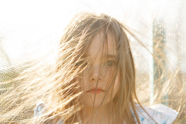 portrait of a girl with her hair down and blowing in the wind.hairstyle without antistatic. windy weather - Foto, Bild