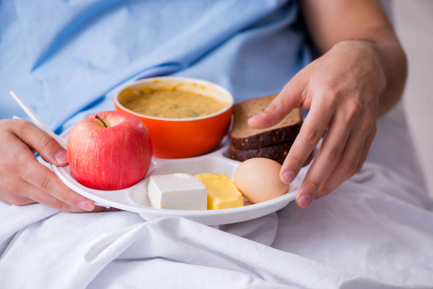 Male patient eating food in the hospital - Photo, image