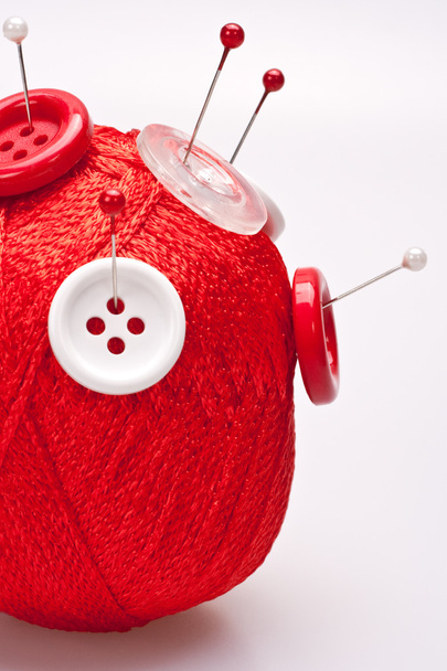 Pins in wool ball with buttons - 写真・画像