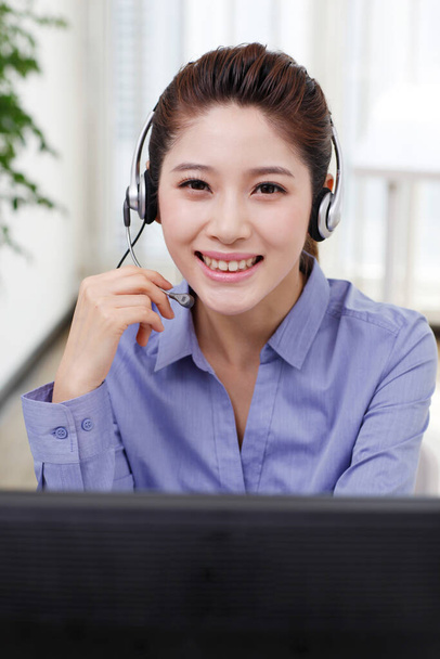 	Businesswoman with headset using computer	 - Photo, Image