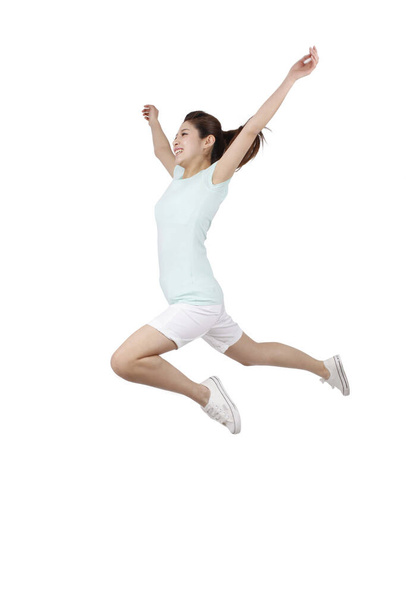 Young woman jumping  on white background - Photo, image