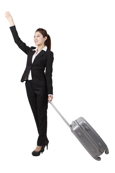 	Businesswoman using cell phone,pulling suitcase	 - Foto, imagen