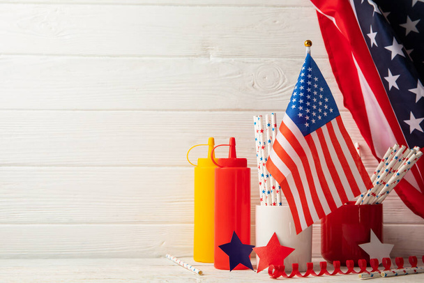 Composition with american flag, bottles for sauce and color stars on wooden background - Photo, Image