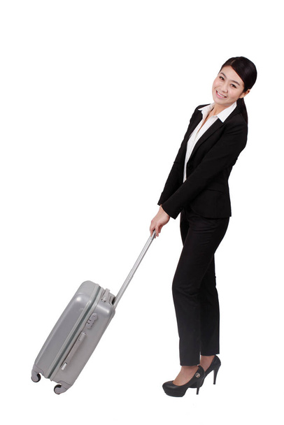 	Businesswoman pulling a suitcase	 - Foto, afbeelding