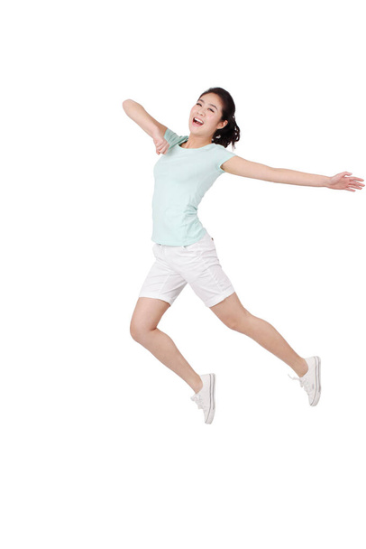 Young woman jumping on white background - Φωτογραφία, εικόνα