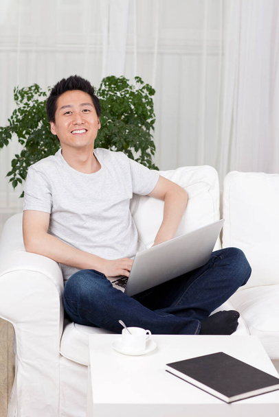 	Cheerful businessman using a laptop computer in sofa	 - Foto, immagini