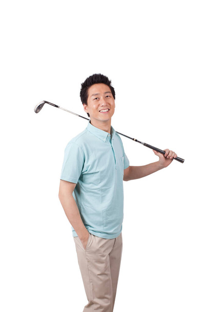 	Young man holding golf swing and smiling 	 - Zdjęcie, obraz