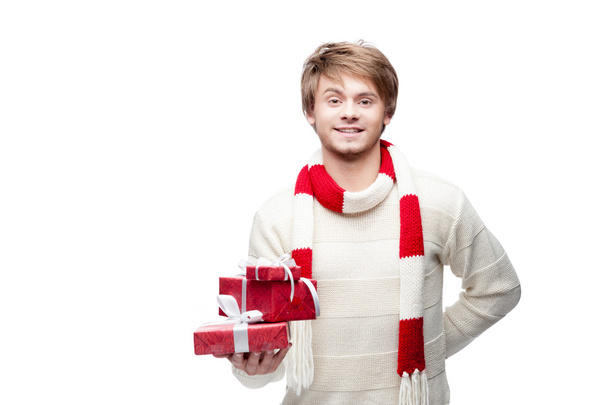 young smiling man holding christmas gifts - Фото, изображение