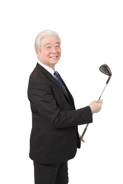 	Senior businessman holding gulf club	 - Фото, изображение