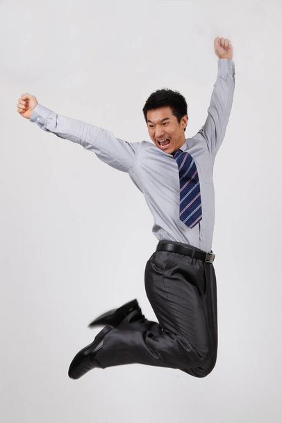 A jumping young business man - Foto, imagen
