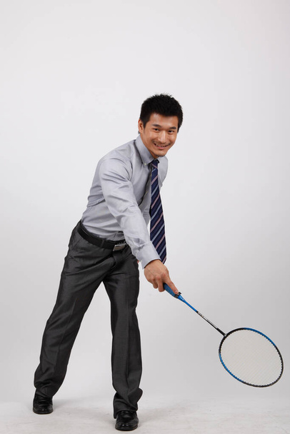 A business man playing badminton - Foto, immagini