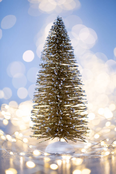 Christmas tree on blue bokeh background. - Valokuva, kuva